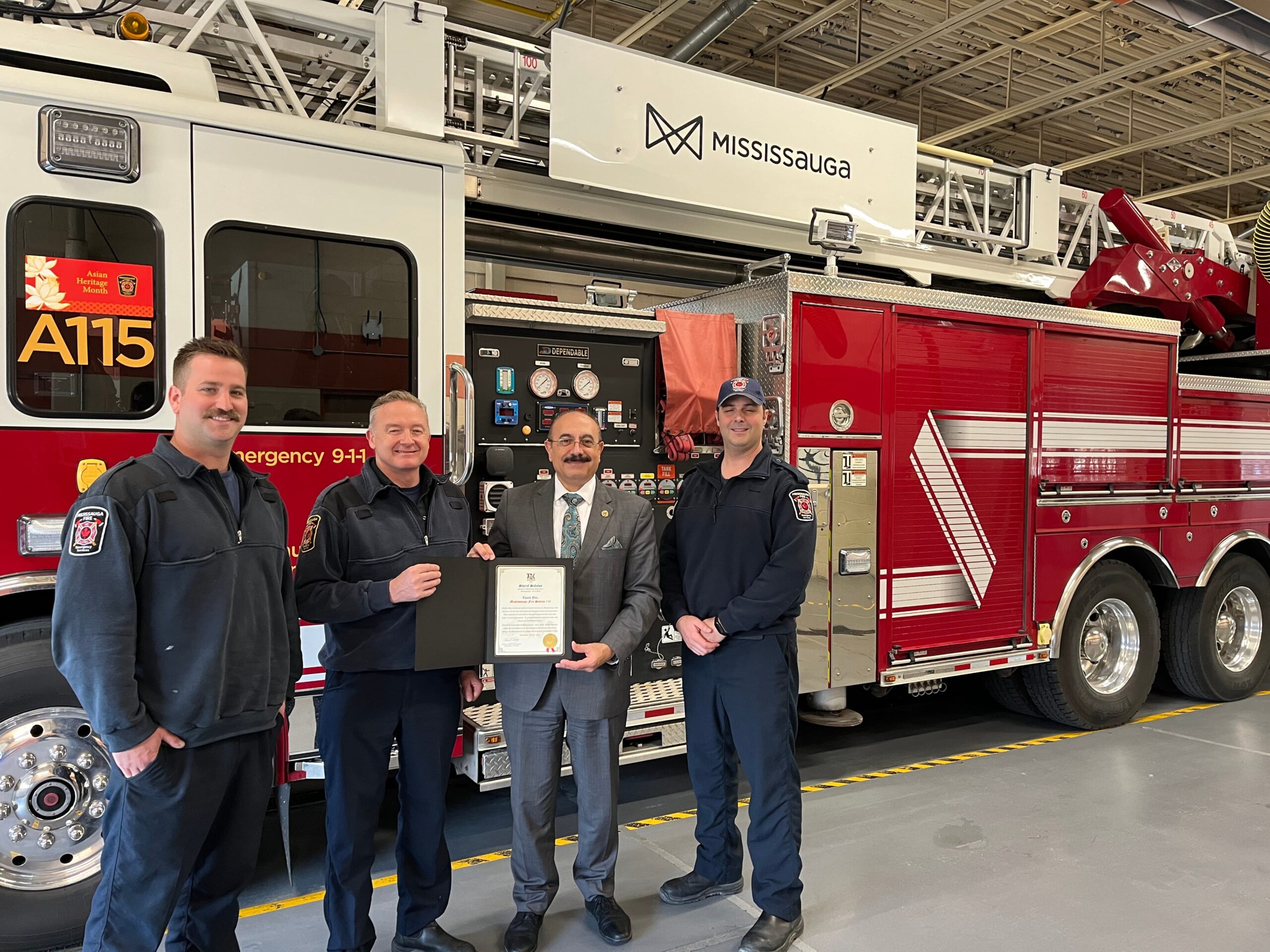 MPP Sabawy gives a congratulatory certificate to Mississauga firefighters on International Firefighters Day.
